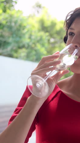 Woman-drinking-champagne-outside-