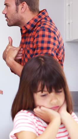 Couple-arguing-in-front-of-their-daughter