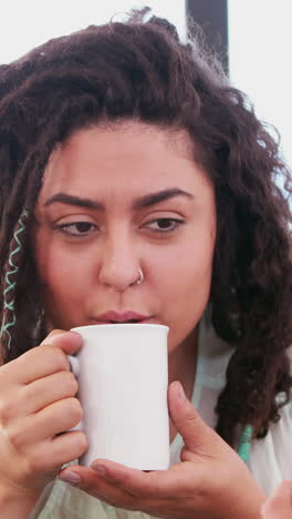 Smiling-lesbian-couple-drinking-coffee-together