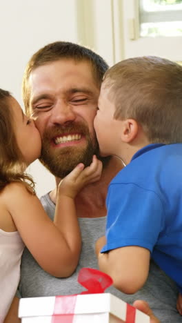 Children-giving-a-kiss-to-their-father