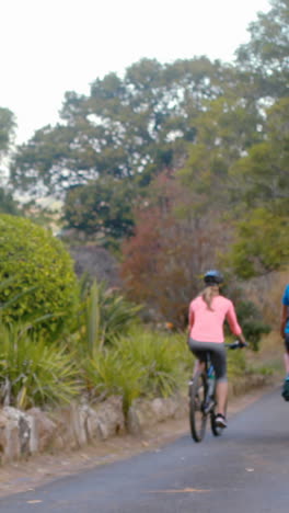 Couple-cycling-on-the-road-in-park