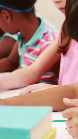 Teacher-helping-pupil-with-laptop