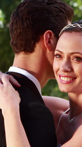 Smiling-bride-embracing-her-new-husband