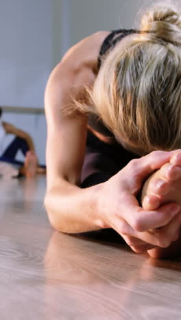 Woman-performing-stretching-exercise