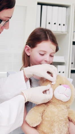 Doctor-examining-a-teddy-bear-