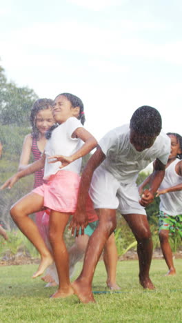 Kids-playing-with-garden-sprinkler