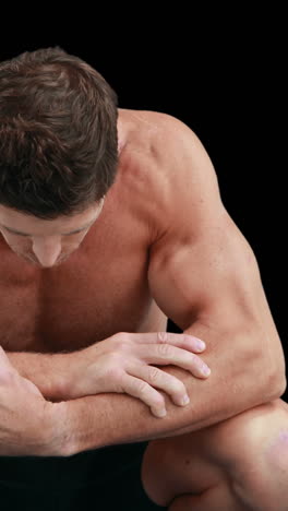 Muscular--man-with-arms-crossed-looking-down