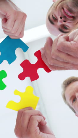 Business-people-holding-piece-of-puzzle-