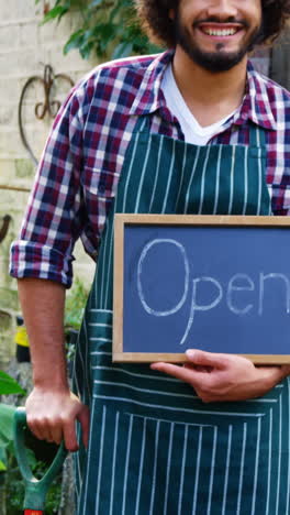 Gardener-holding-open-sign