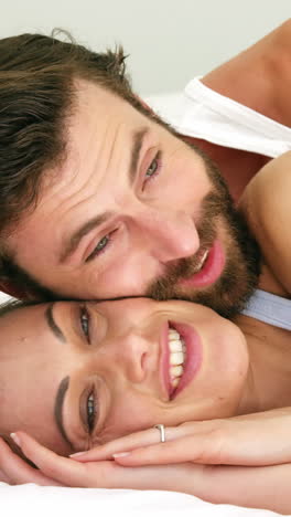 Cute-couple-lying-on-a-bed-embracing-each-other