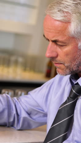 Lonely-businessman-drinking-a-beer-after-work