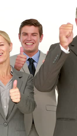 Business-people-looking-at-camera-with-thumbs-up