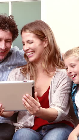 Happy-family-having-video-call-with-tablet