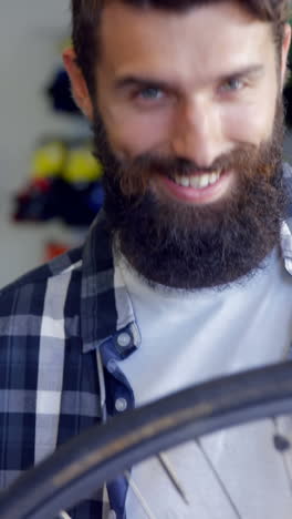 Mechanic-repairing-bicycle-in-workshop