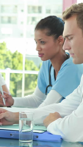 Team-of-smiling-doctors-having-a-meeting