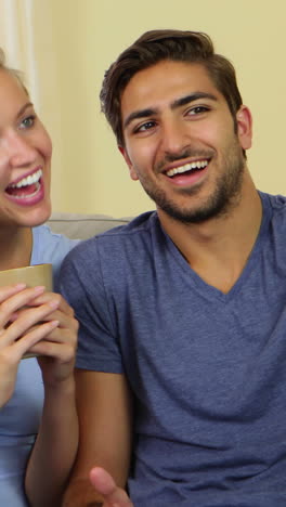 Smiling-man-taking-a-photo-of-himself-and-his-pretty-girlfriend