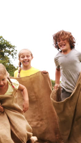 Kinder-Veranstalten-Einen-Sackhüpfen-Im-Park