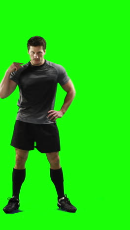 Serious-rugby-player-gesturing-in-front-of-camera-