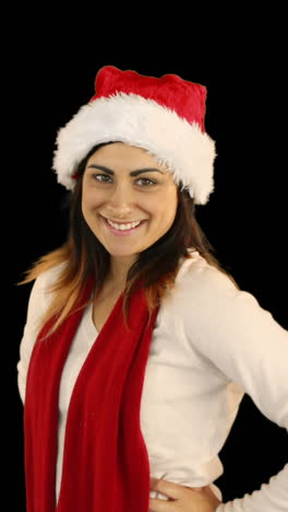 Woman-in-santa-hat-and-warm-clothing-blowing-over-hands-