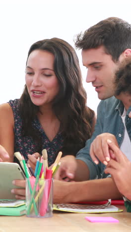 Casual-business-people-looking-at-laptop-computer-