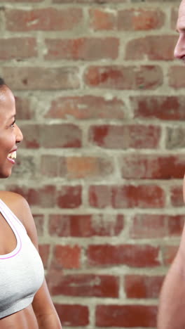 Fit-couple-talking-in-crossfit-gym