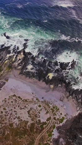 Aerial-view-of-waves-crashing-on-coastline