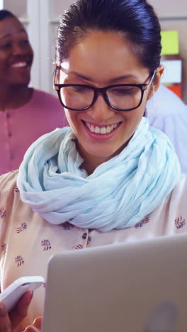 Female-business-executive-discussing-over-digital-tablet