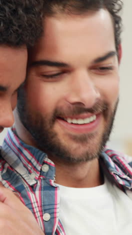 Gay-couple-relaxing-on-the-couch-using-laptop