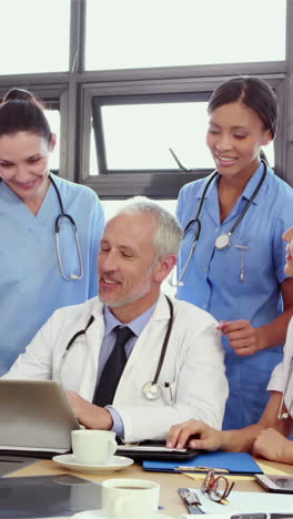 Doctors-looking-at-laptop-and-discussing