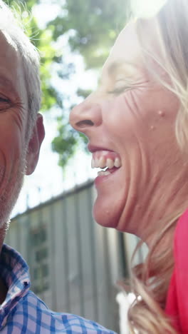 Mature-couple-is-embracing-and-laughing-in-the-street-