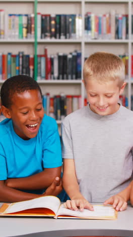 School-kids-reading-book-together-in-library