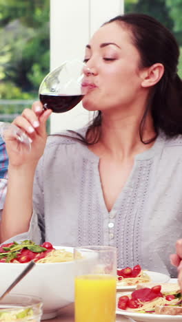 Happy-family-toasting-during-lunch