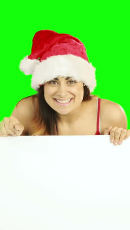 Beauty-brunette-in-santa-hat-showing-white-poster