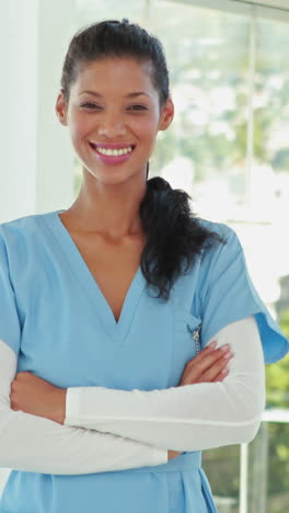 Smiling-doctor-with-arms-crossed-looking-at-camera