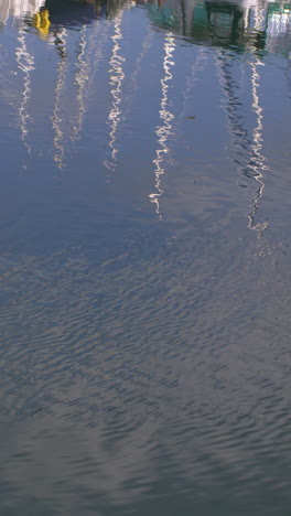 Fishing-boats-reflected-in-the-water-in-the-morning