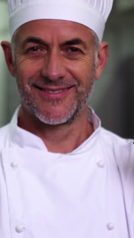 Head-chef-holding-a-ladle-smiling-at-camera