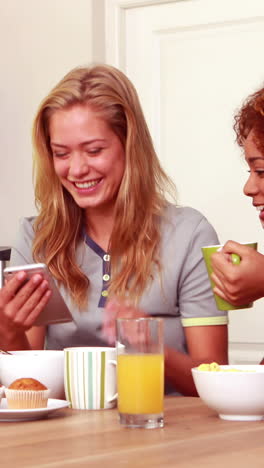 Friends-laughing-while-eating-breakfast-together