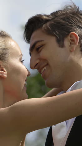 Laughing-newlyweds-kissing-outside-on-a-windy-day