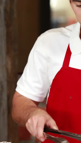 Smiling-waiter-with-arms-crossed