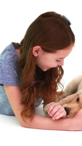 Smiling-girl-playing-with-cute-puppy