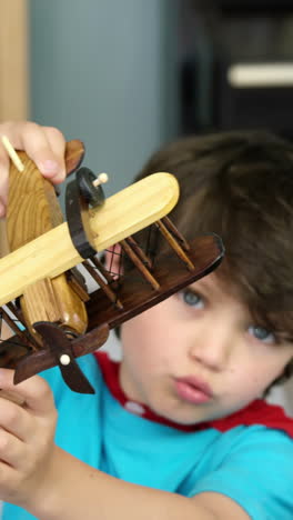 Boy-playing-with-a-toy-plane-