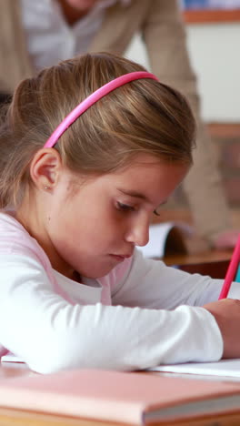 Schoolchildren-colouring-in-books-in-classroom