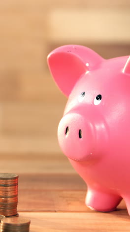 Woman-putting-coin-in-piggy-bank