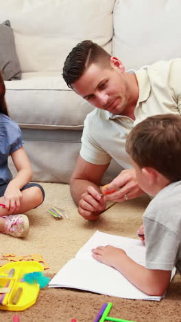 Young-siblings-doing-arts-and-crafts-on-the-rug-with-parents