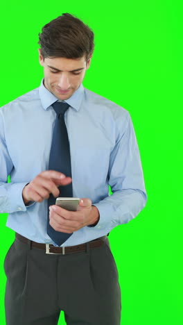 Businessman-standing-and-using-a-smartphone