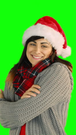 Woman-in-santa-hat-and-warm-clothing-blowing-over-hands-