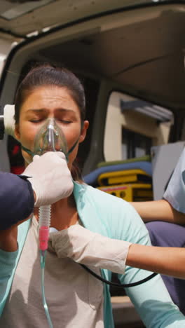 Patient-receiving-oxygen-mask-from-ambulance-team-