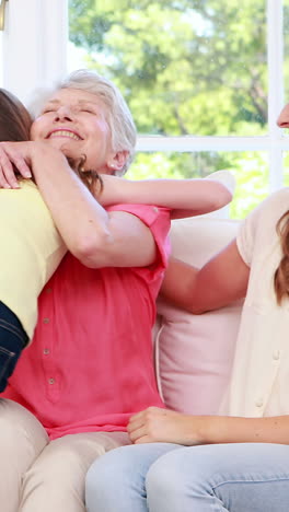 Cute-child-embracing-grandmother-and-mother