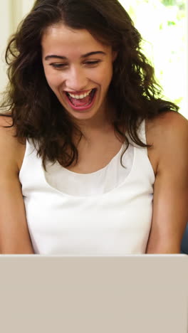 Smiling-family-looking-at-their-laptop