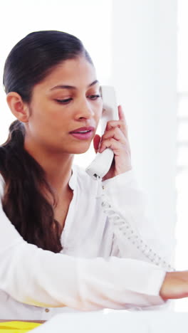 Woman-in-office-making-call